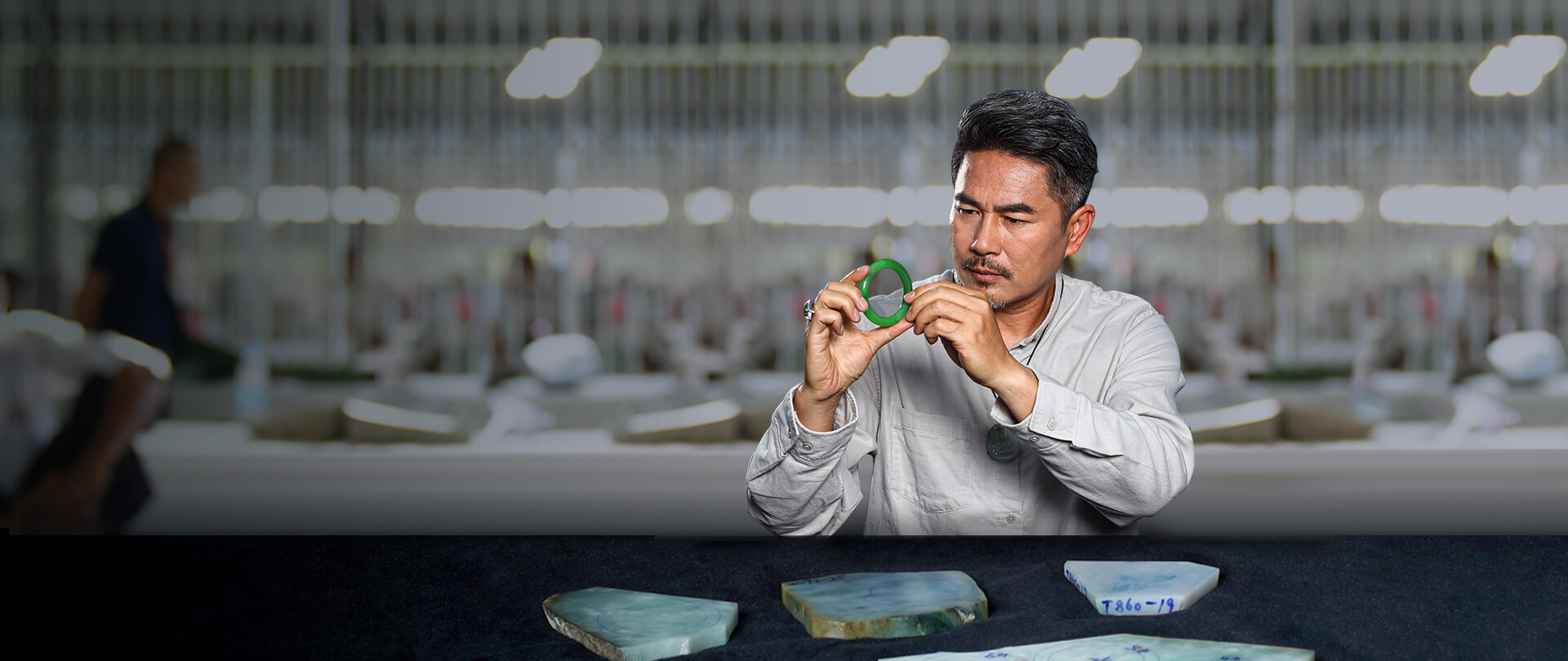 Master Chen examining a jadeite bangle at the stone market